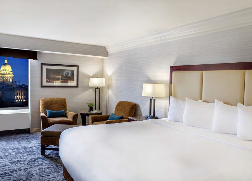 Governor's Club room with king bed, two chairs and Capitol view