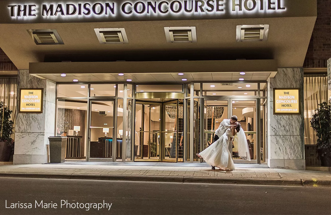 Bride and groom in front of the hotel by Larissa Marie Photography