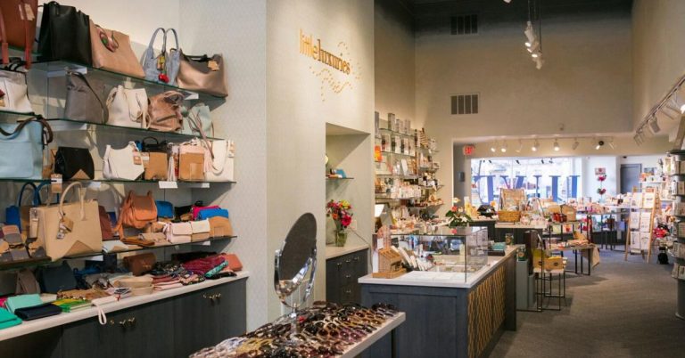 The storefront of Little Luxuries in downtown Madison, featuring a charming exterior and colorful window displays showcasing unique gifts, children’s toys, books, and playful boutique finds.
