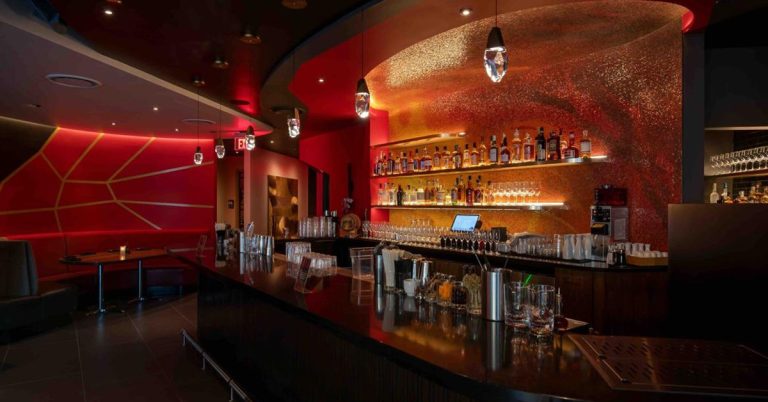 The bar and dining room at RED in Madison, featuring a modern, upscale interior with a polished bar area, ambient lighting, and a stylish dining space for japaneese cuisine, sushi, and cocktails.