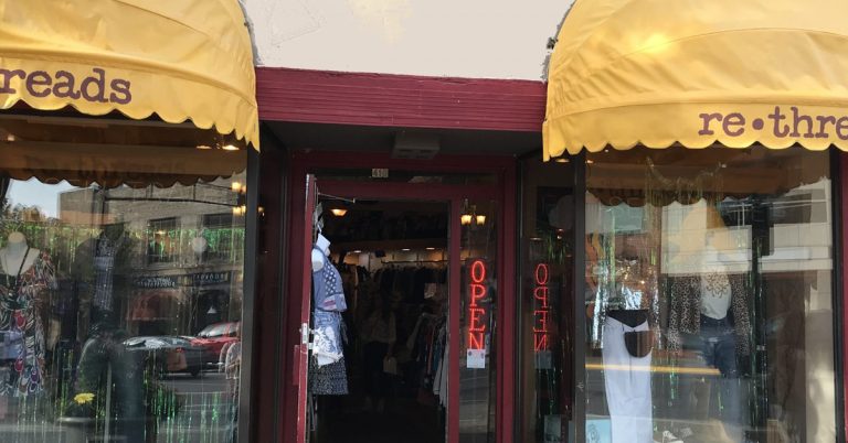 The storefront of ReThreads in downtown Madison, featuring a welcoming boutique exterior and window displays showcasing curated secondhand clothing, accessories, and sustainable fashion finds.