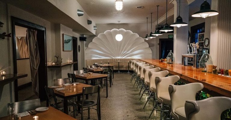 The dining room and bar at Tempest Oyster Bar in Madison, featuring a lively, nautical-inspired interior with a full bar, cozy seating, and a fresh seafood-focused atmosphere.