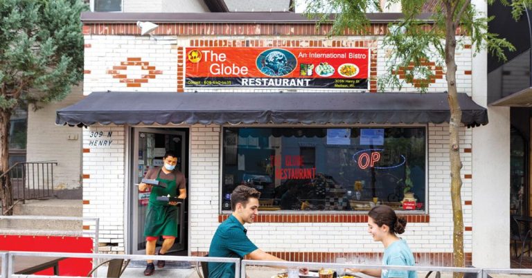 The Globe restaurant in Downtown Madison, showing a picture of the building as well as a couple enjoying a meal on the small patio.